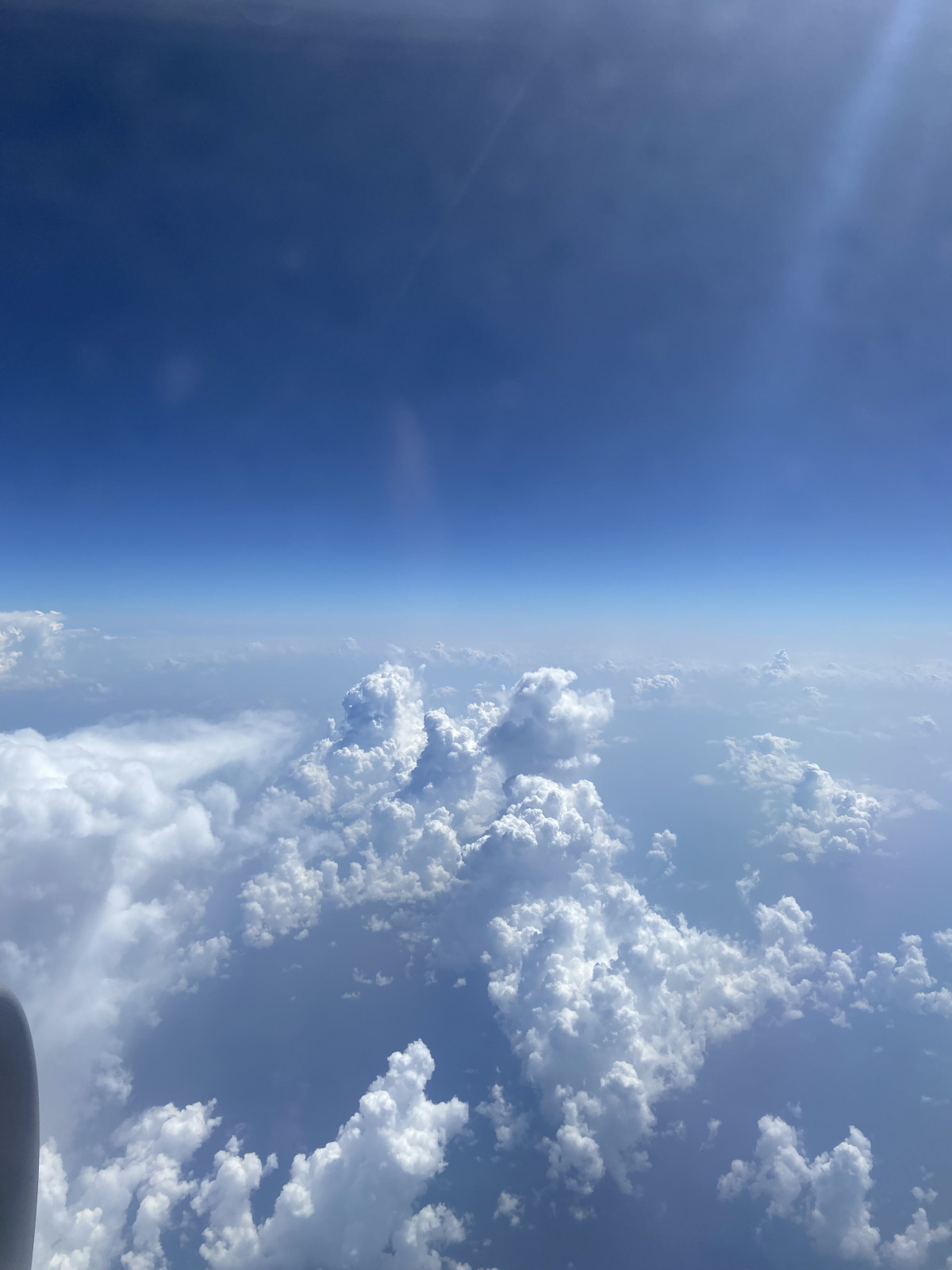 A stunning view of the clouds and blue sky from a plane window